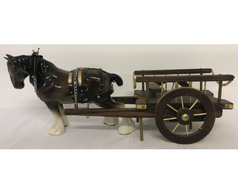 A large ceramic shire horse together with a wooden cart. Shire horse approx. 24cm tall.