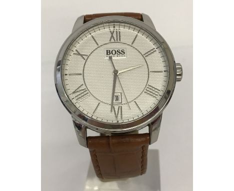 A men's modern wristwatch by Hugo Boss on a brown leather strap. White engine turned decoration face silver tone hands and ho