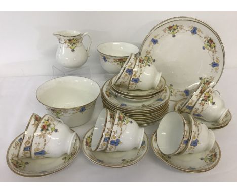 A Victorian ceramic tea set with gilt detail and decorative floral swag design. Comprising: 2 sandwich plates, 10 side plates