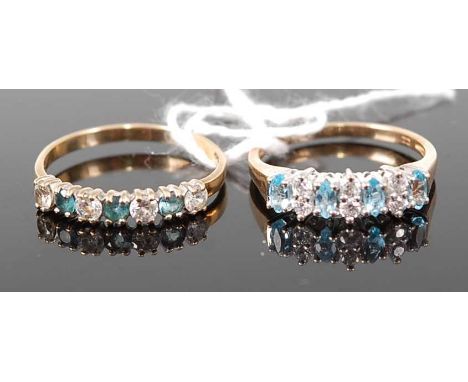 A modern 9ct gold, blue topaz and white stone set half eternity ring, 1.3g, size N; together with another similar example, 1.