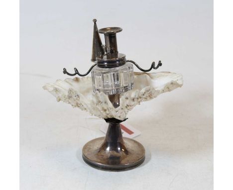 A desk stand having silver candlestick with snuffer, silver mounted inkwell with pen holder mounted in a shell on a silver ba