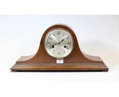 A 1930s oak cased mantel clock, having a silvered dial with Arabic numerals and eight day movement striking on a gong, h.22cm
