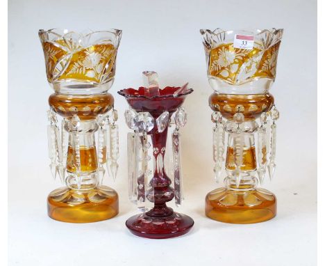 A pair of Bohemian style amber overlaid etched and cut glass table lustres, each with glass prism drops, h.31cm; together wit