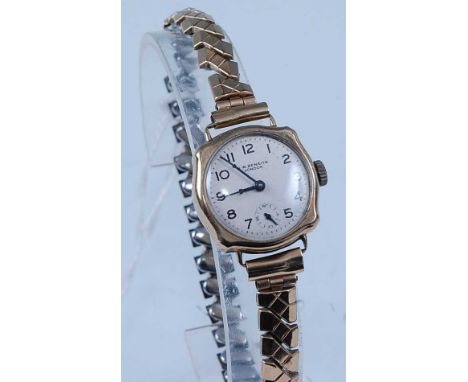 A JW Benson lady's 9ct gold cased manual wind wristwatch, case dia.22mm, on gilt metal expanding link bracelet