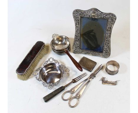Two boxes of miscellaneous items, to include silver clad easel photograph frame, silver plated bottle coaster, loose flatware