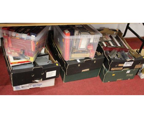 Eight boxes of model railway related items to include transformers, controllers, VHS cassettes, and DVDs, model trains, etcCo