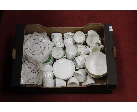 A box containing a 20th century floral gilt decorated part tea service