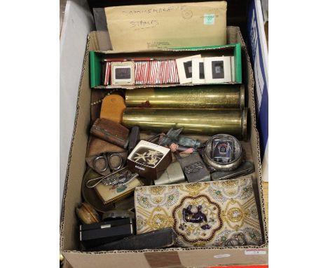 A box of miscellaneous items, to include a pair of brass shell cases, pocket cigarette lighters, glass projector slides etc 