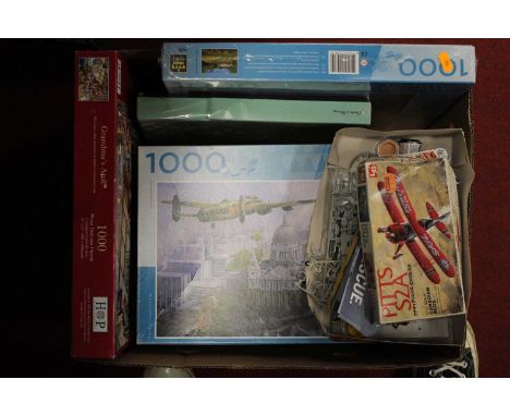 A box containing a collection of various model kits and jigsaw puizzles, to include Airfix Supermarine Spitfire, and an Airfi