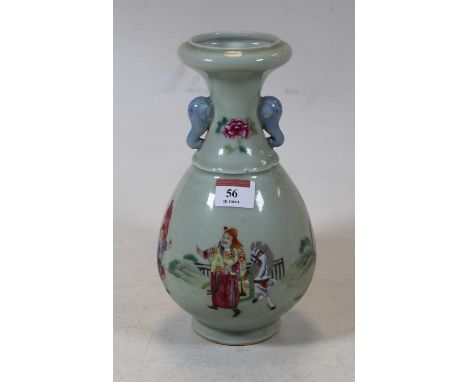 A Chinese celadon glazed vase, having a flared rim to a slender neck and bulbous body, with elephant mask handles, the body e