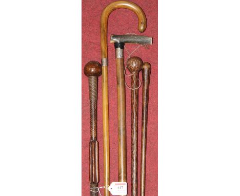 A 20th century walking stick with a silver collar together with four others 