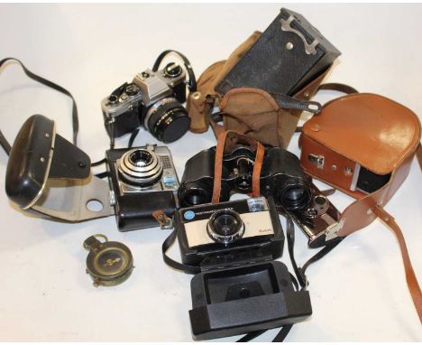 A collection of cameras and accessories to include Olympus OM10, and a pair of Starlight coated 8x30 field binoculars, milita