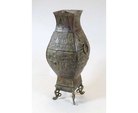 A modern Chinese bronzed metal vase, of square baluster form, having incised and relief figural decoration, with ring handles