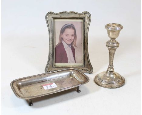 An Art Nouveau silver clad easel photo frame, together with a silver table candlestick on a loaded base and a part silver des