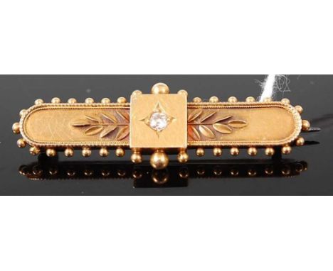 A vintage 15ct gold and round cut diamond set bar brooch, the single diamond weighing approx 0.1 carats, the whole with steel