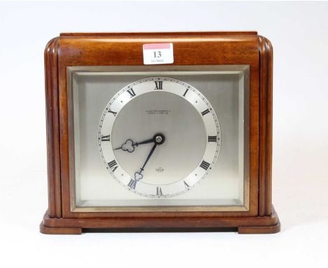 An Elliott mahogany cased mantel clock, having a square silvered dial with Roman numerals, signed The Northern Goldsmiths Co 