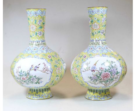 A pair of continental enamel vases, each having a slender neck to a bulbous lower body and circular footrim, on a yellow grou