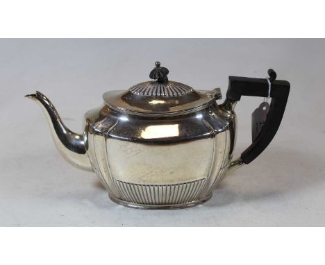 A George V silver teapot of oval half reeded form with ebonised finial and handle, maker Henry Stafford Ltd, Sheffield 1914, 