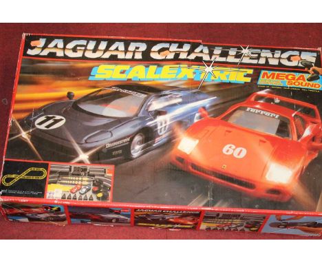 A Scalextric Jaguar Challenge track set, together with various other games including Shove Ha'penny and a dartboard