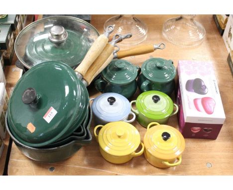 A graduated set of three Le Creuset green enamelled saucepans and covers; together with a single Le Creuset saucepan and cove