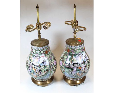 A pair of Chinese brass mounted table lamps, each of baluster form, enamel decorated with figures within landscapes and furth