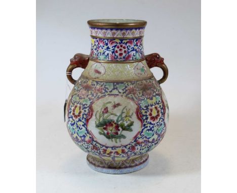 A Chinese porcelain vase, of baluster form, having twin elephant handles, enamel decorated with flowers, Greek Key border, an