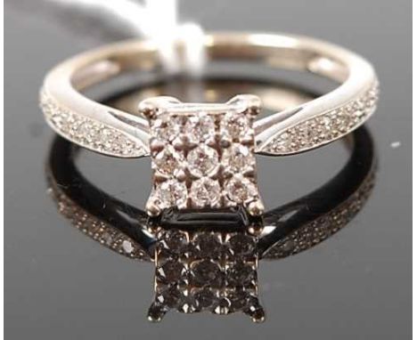 A modern 9ct yellow and white gold diamond dress ring, the square head set with nine small brilliants, the shoulders further 