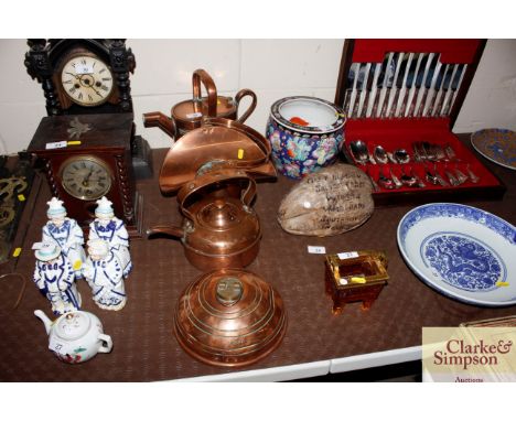 An antique copper country house watering can; a copper foot warmer; a copper kettle and a planter with swing handle 