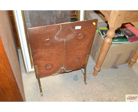 A copper and brass fire screen 