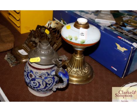 A Victorian opaque glass table oil lamp; and a salt glazed German pewter lidded tankard