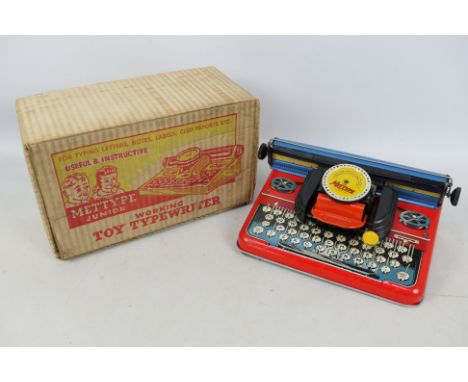 Mettype - A boxed Mettype Junior Toy Typewriter. The tinplate model appears in Good condition overall with light signs of age