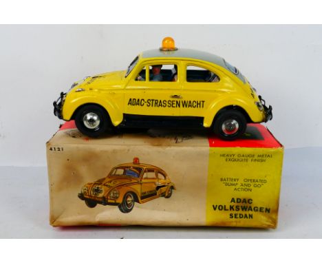 Bandai - A boxed battery powered tinplate Volkswagen Beetle in ADAC livery with bump and go action. The model appears in Very