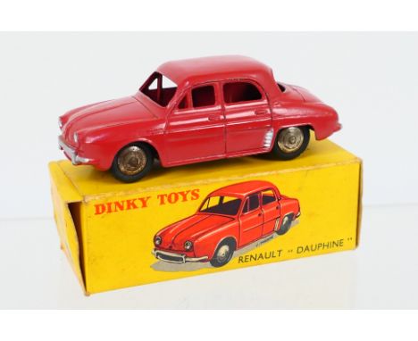 Dinky - A boxed French Dinky Renault Dauphine # 24E / 524. This dark red model without windows appears in Very Good condition