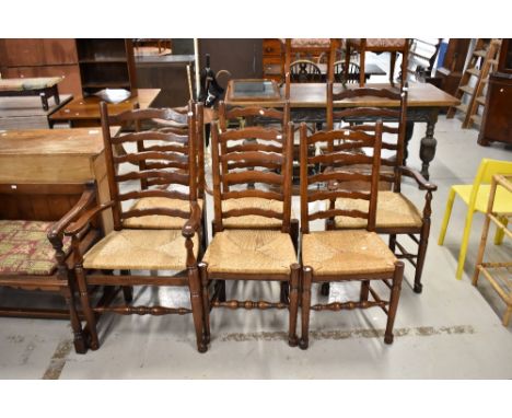 A set of six (four plus two) oak ladder back dining chairs having rush seats