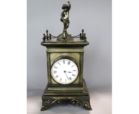 French brass cased figural mantle clock mounted by a cherub with gallery rail, twin cherub type handles and drum head movemen