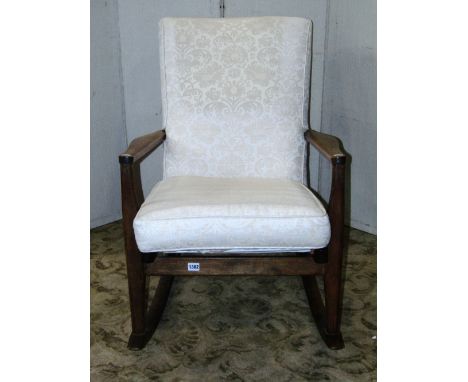 A vintage Parker Knoll rocking chair model number 973-4, with stained beechwood frame, sprung seat with loose cushion and uph