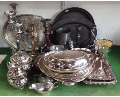 A large collection of various silver plated wares to include a five branch silver plated candelabra, a serpentine shaped gall