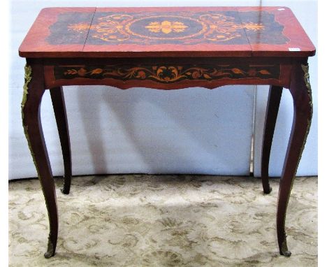 A good quality reproduction Italian floral marquetry inlaid games table, the reversible and folding top revealing a backgammo