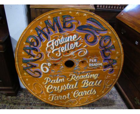A vintage circular wooden board, with hand painted finish advertising Madame Zola Fortune Teller Palm Crystal Ball and Tart C