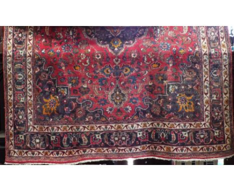 Large Persian Hamadam village carpet with central medallion on a red ground, 350 x 250 cm