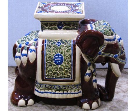 A glazed ceramic conservatory or garden seat in the form of a elephant in ceremonial dress