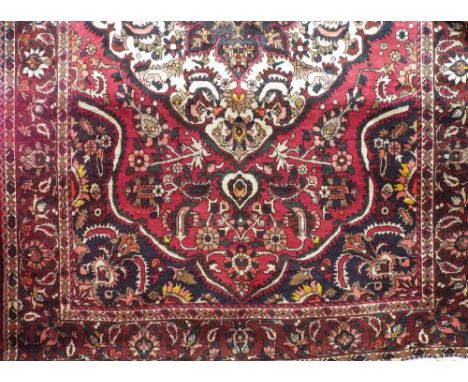 Full pile hand woven Persian Bakta carpet, traditional decoration, red ground, 320 x 210 cm