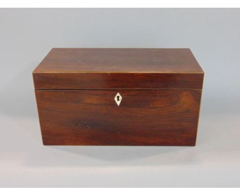 Regency rosewood and boxwood inlaid tea caddy, the hinged lid enclosing an interior fitted with two lidded compartments and c