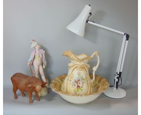 An Edwardian jug and basin set with printed floral detail, 19th century bisque figure of a Dandy, a carved hardwood figure of