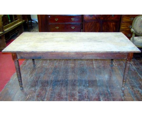 A 19th century elm farmhouse kitchen table, the plank top raised on four turned tapering bobbin supports together with a matc