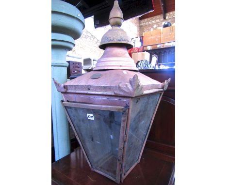 A lantern hood of square tapered form with glazed panels beneath a canopy and raised finial, the metal frame with later spray