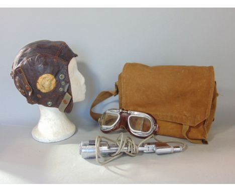 A vintage soft leather flying helmet, stamped 10634 with War Dept arrow, together with a pair of similar period flying goggle