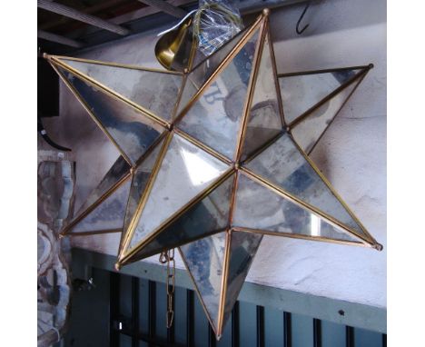 A contemporary star cluster shaped hanging ceiling light with segmented mirror panels