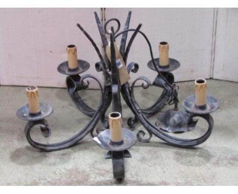 An iron work five branch hanging ceiling light with simple scroll and hammered detail, together with a pair of matching three