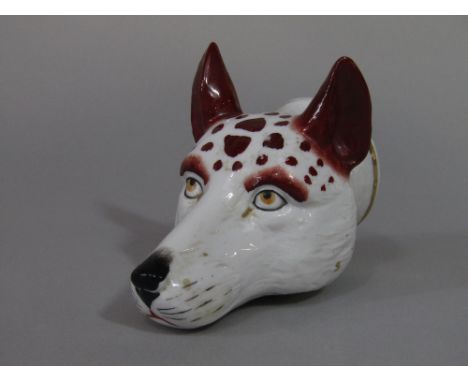 A 19th century stirrup cup in the form of a fox mask, 11 cm long approx